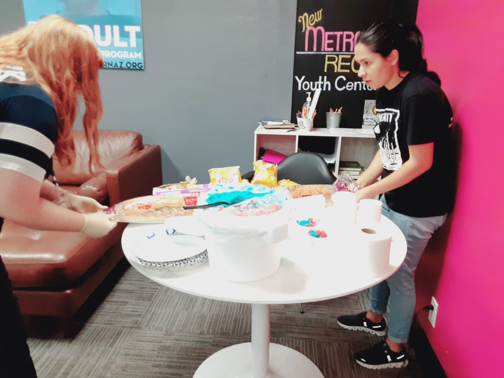 Photo of two people serving snacks in the Metro youth center